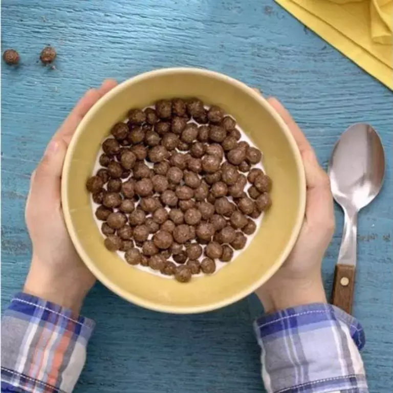 Bowl of Nesquik with hands around it