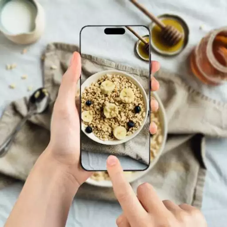 Person taking a photo of their breakfast cereal