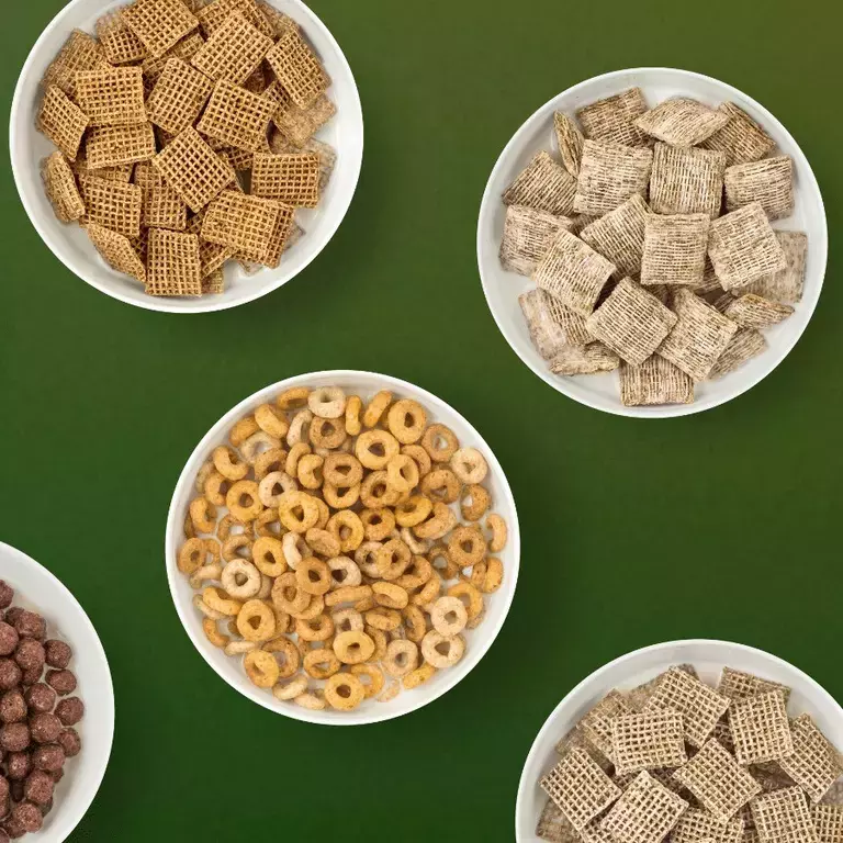 Bowls of Nestlé Cereals top down on a green background