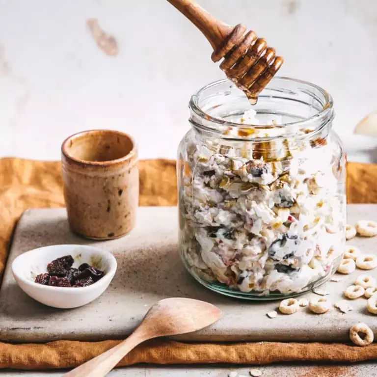 Cheerios apple &amp; cinnamon overnight cereal in glass jar with honey drizzle