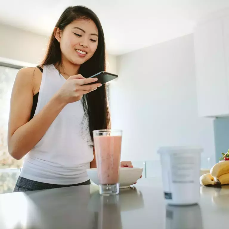 Woman taking a photo of a bowl of cereal