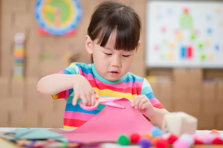 toddler girl making craft