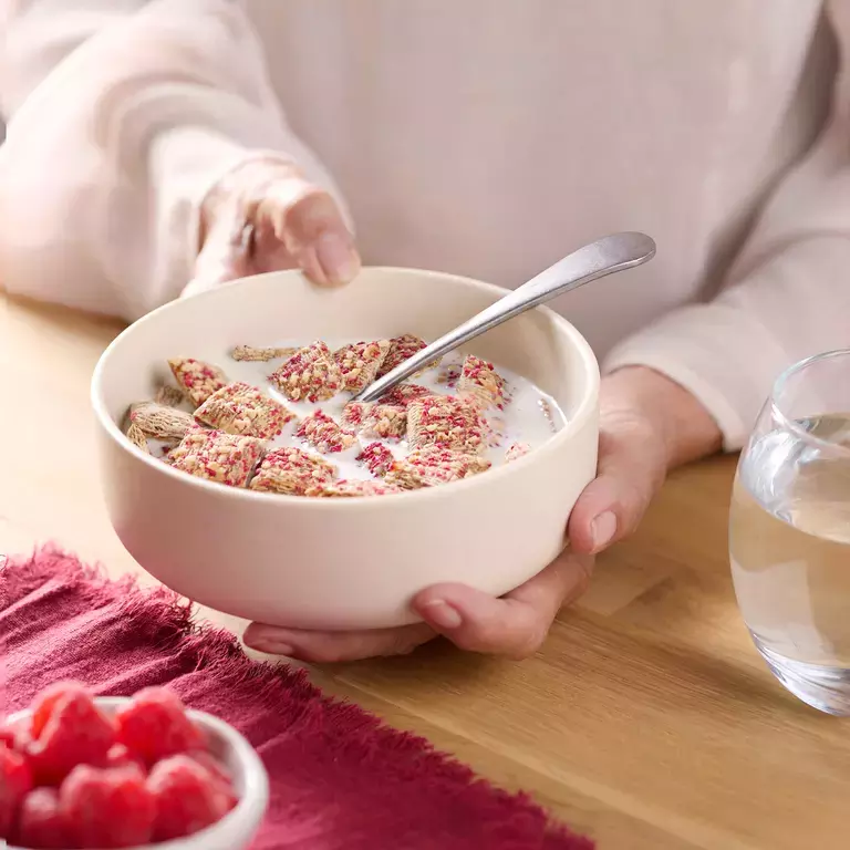 Hands holding a bowl of Shredded Wheat Healthy Heart Cereal