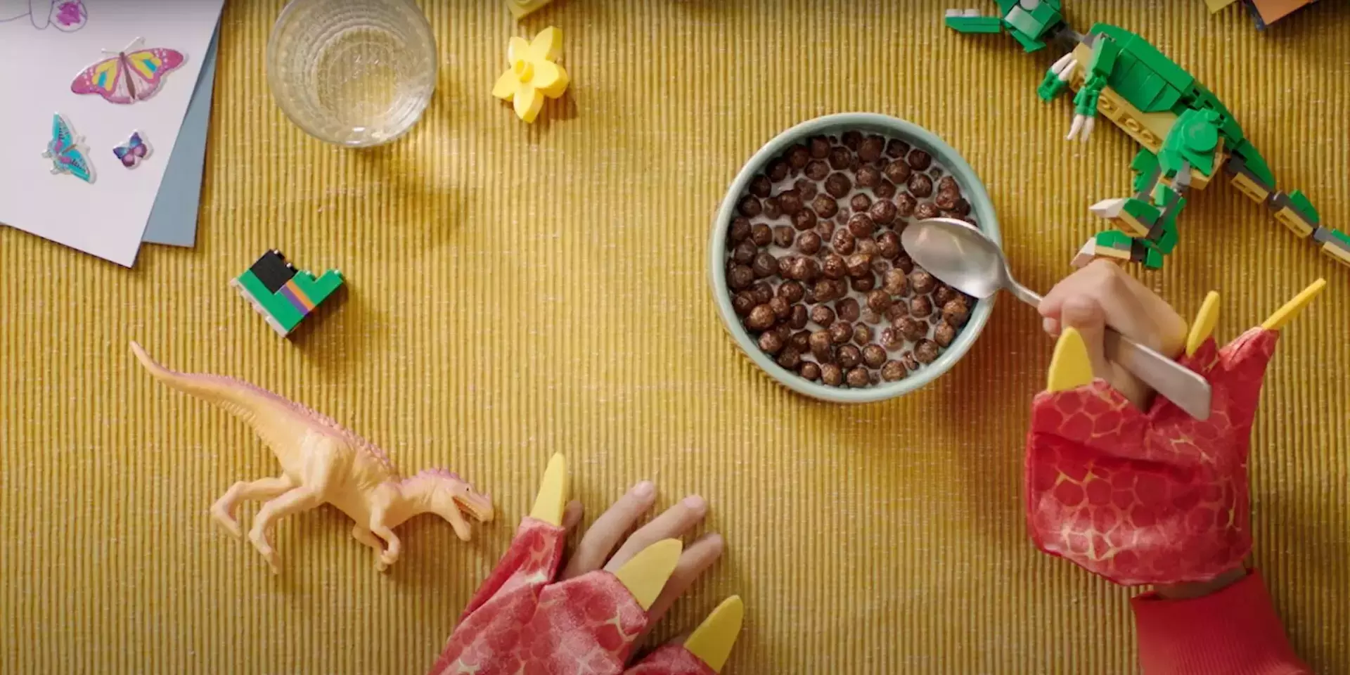 Children dressed as a dinosaur eating Nesquik cereal from a bowl